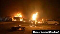 Vehicles on fire after a roadside bomb attack in Quetta that killed at least 15 soldiers and civilians on August 12.