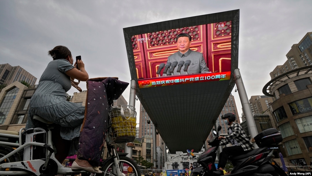 A big screen outside a shopping mall in Beijing shows Chinese President Xi Jinping speaking during an event to commemorate the 100th anniversary of China's Communist Party.