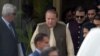 Pakistani Prime Minister Nawaz Sharif (C) leaves with his son Hussain Nawaz (2R) after appearing before an anti-corruption commission at the Federal Judicial Academy in Islamabad on June 15