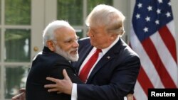India's Prime Minister Narendra Modi hugs U.S. President Donald Trump as they give joint statements in the Rose Garden of the White House in Washington on June 26.