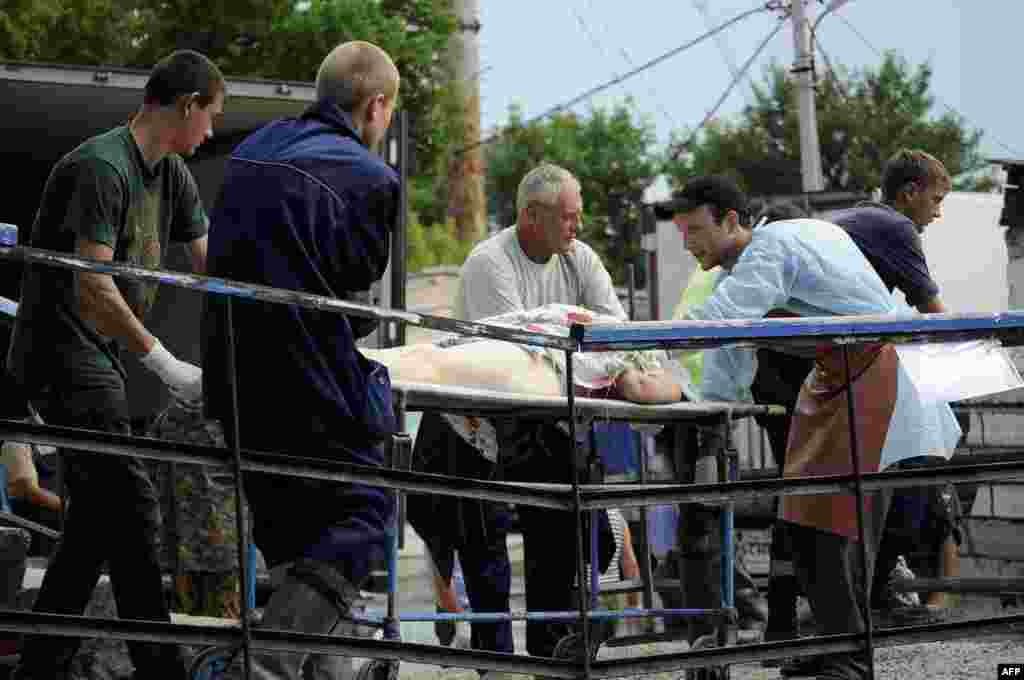 Bodies of floods victims are transported from a local mortuary to a truck in the town of Krymsk on July 8.
