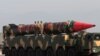 Pakistani military personnel stand beside a Shaheen III surface-to-surface ballistic missile during Pakistan Day military parade in Islamabad, March 2017.