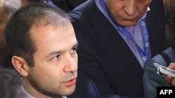 Switzerland -- Abkhazia's Deputy Foreign Minister Maksim Gvinjia is surrounded by reporters upon his arrival for a second round of talks at the UN Offices in Geneva, 19Nov2008