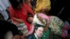 A supporter of Pakistani Prime Minister Nawaz Sharif passes out after the Supreme Court's decision to disqualify Sharif in Lahore on July 28.