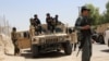 Afghan soldiers sit on an armored vehicles during a battle with the Taliban militants in Helmand's Gereshk district on July 22.