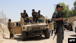 Afghan soldiers sit on an armored vehicles during a battle with the Taliban militants in Helmand's Gereshk district on July 22.