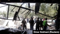 FILE: Afghan security forces inspect the site of a suicide bomb attack in Kabul on August 29.