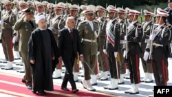 Iranian President Hassan Rohani (L) and visiting Afghan President Ashraf Ghani in Tehran in April.