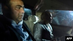 Pakistani Muttahida Qaumi Movement (MQM) political party top leader Farooq Sattar (R) and lawmaker Khawaja Izhar ul Hassan look on as they sit in a car after their arrest by paramilitary rangers in Karachi on August 22.