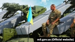 Український воїн-артилерист і зенітно-ракетні комплекси Оса-АКМ. Місто Чугуїв, Харківщина, 22 серпня 2015 року (ілюстраційне фото)