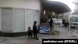 Azyk dükanynyň öňünde duran çagalar 